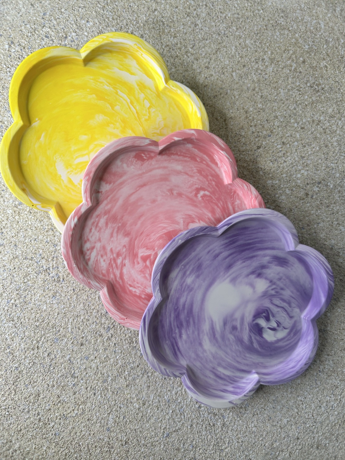 Handmade Home Accessories - three candle dishes stacked against each other in a floral shape in marble design in pink, purple and yellow