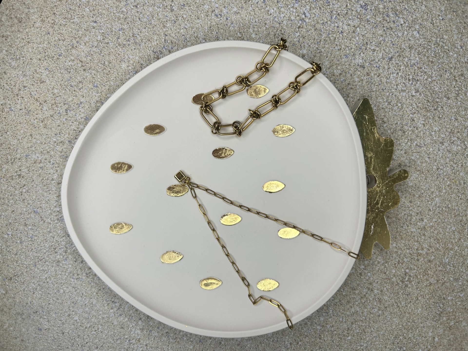 Handmade Homes Accessories - cream and gold strawberry trinket plate displaying a necklace and bracelet.