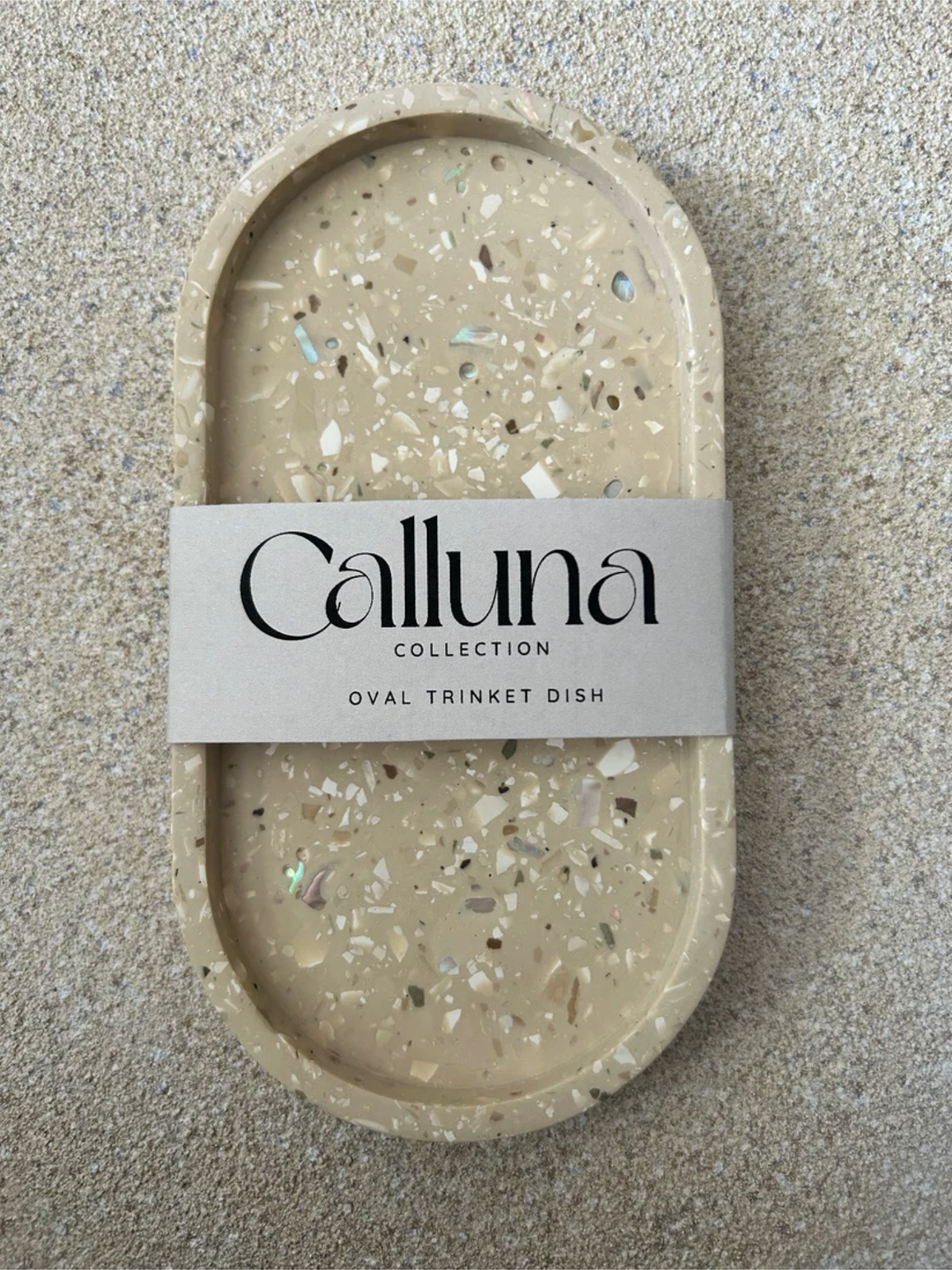 Handmade Home Accessories - A single brown terrazzo tray with a belly band across the centre that states the brand Calluna Collection.