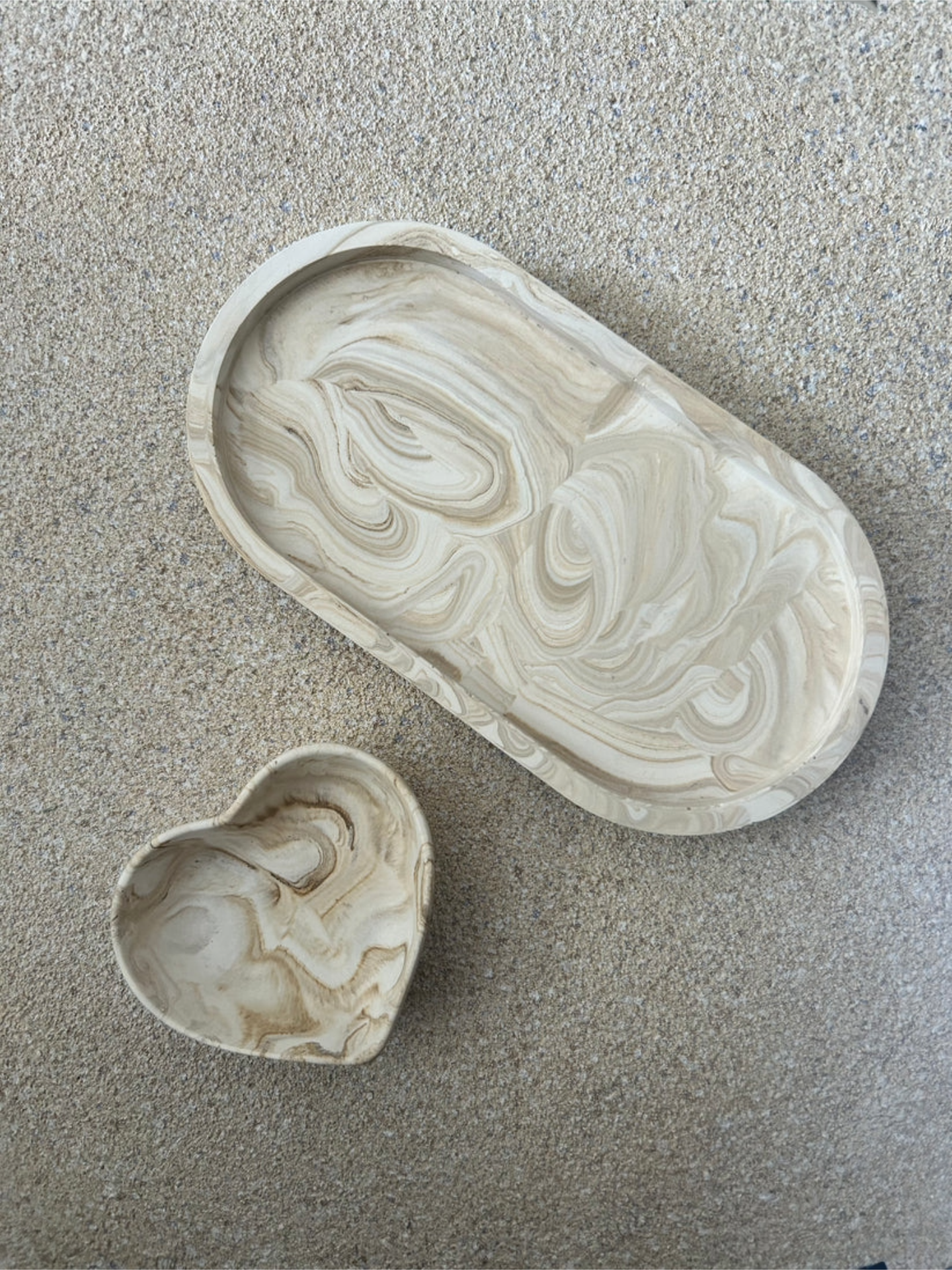 Handmade Home Accessories - an oval, beige marble trinket tray and matching beige marble heart dish.