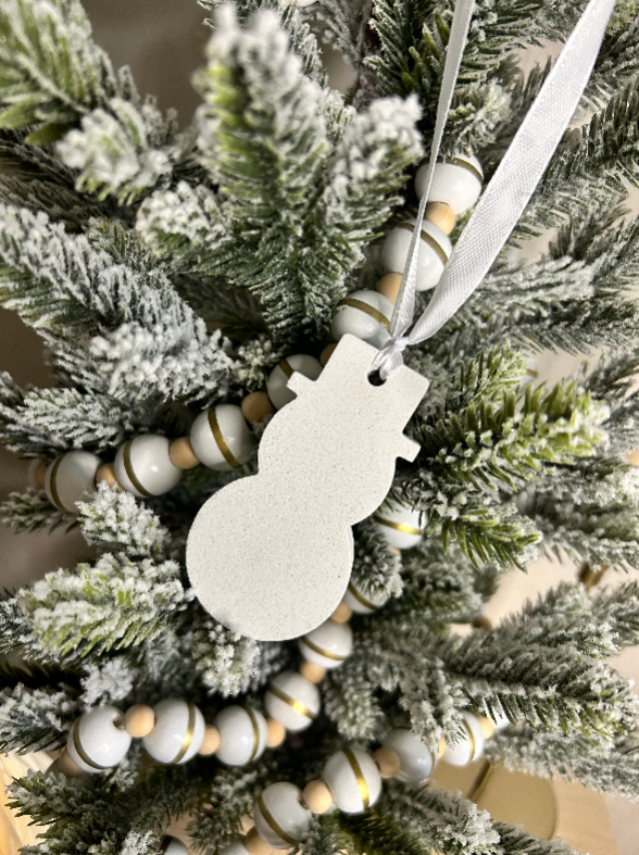 Handmade Home Accessories- A sparkling snowman christmas tree decoration on a christmas tree showing neutral christmas decor.