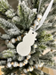 Handmade Home Accessories- A sparkling snowman christmas tree decoration on a christmas tree showing neutral christmas decor.