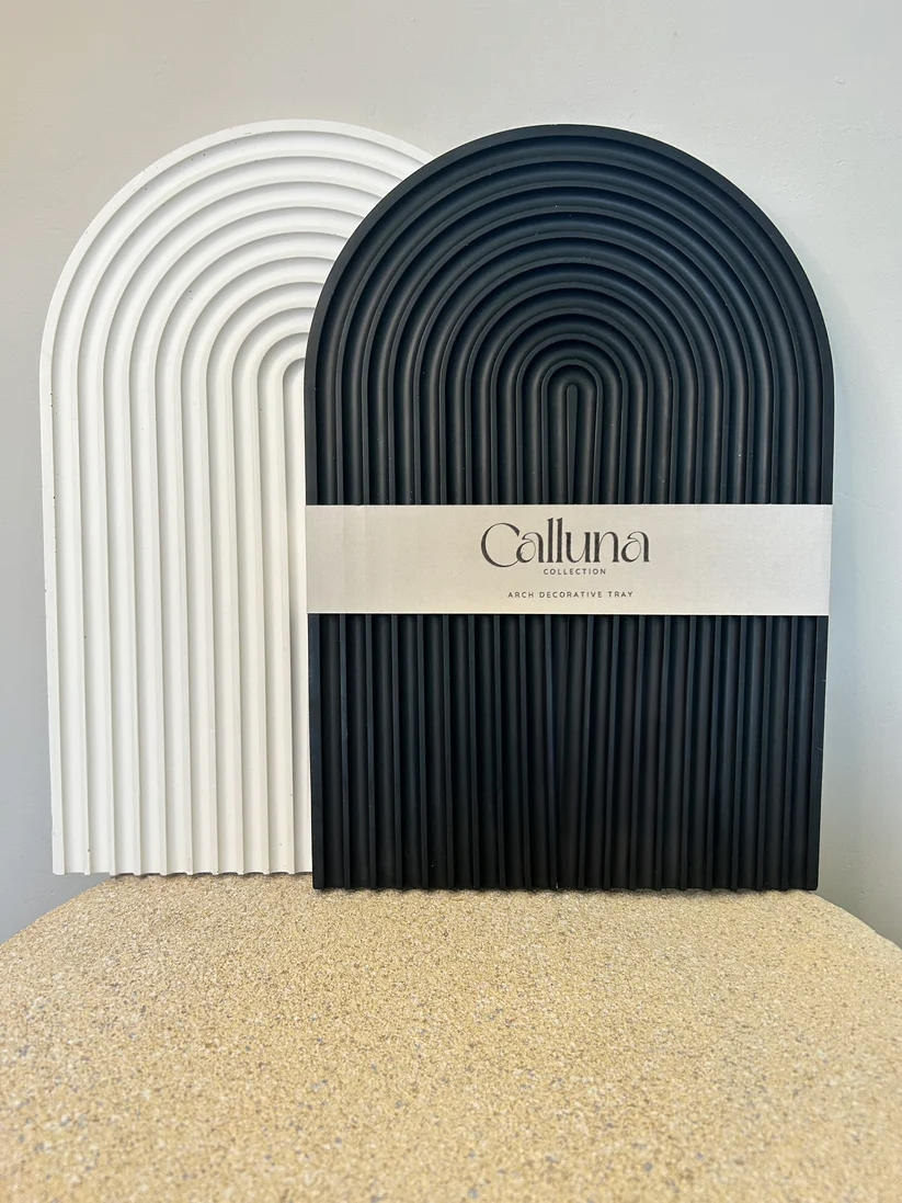 Handmade Home Accessories - two large arch trays, one black, one white with a bely band around that says calluna collection.