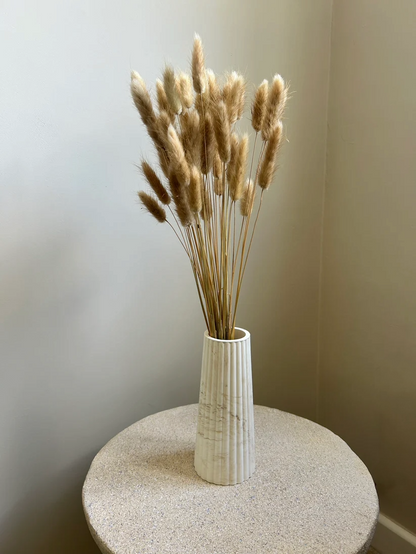 Handmade Home Accessories - a brown marble tall vase on a stone table with bunny tails in