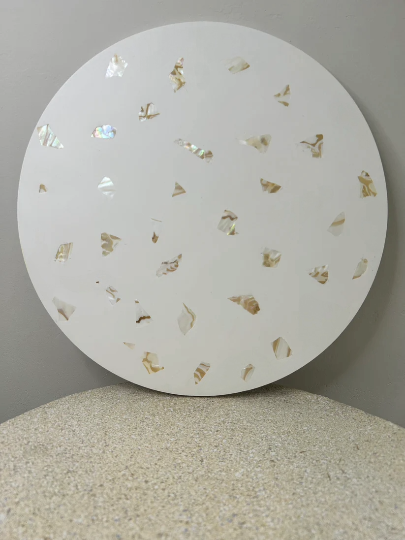 Handmade Home Accessories - a front on view of a white circle decorative tray with real abalone shell pieces in that are shining in the light