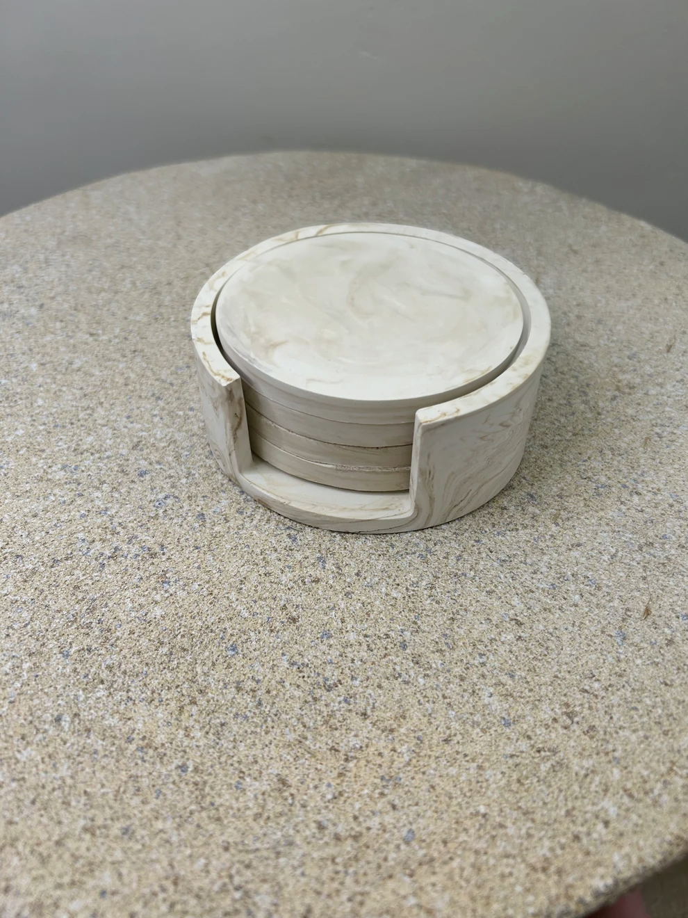 Handmade Home Accessories - an imahe of a coaster stack with four coasters in a coaster holder, the coasters are beige marble