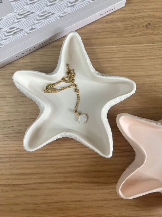 White star-shaped ceramic trinket dish styled with a delicate gold necklace and shell pendant, placed on a wooden surface for a natural, minimal aesthetic.