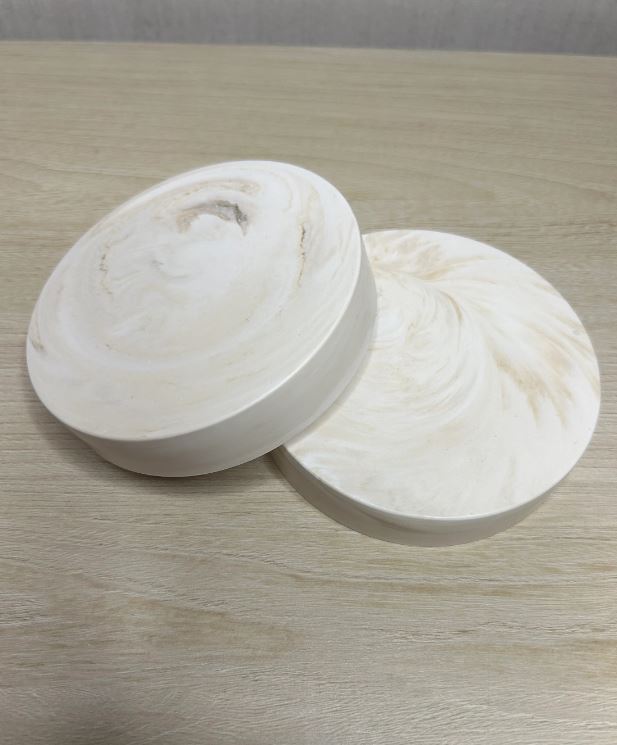 Handmade Home Accessories - two beige marble chunky coasters stacked to show the chunky edge on light wood.