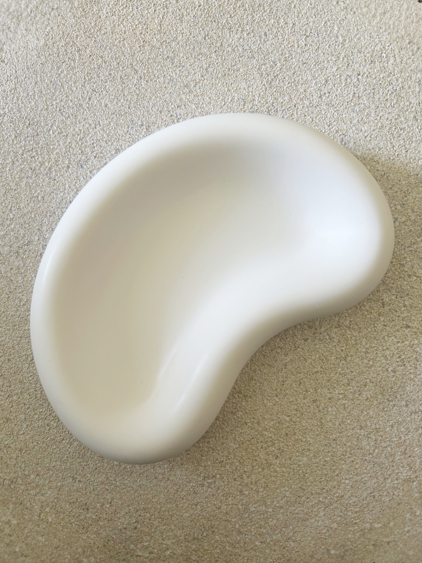 Handmade Home Accessories - Birds eye view of the plain white jelly bean shaped trinket tray on a natural stone background