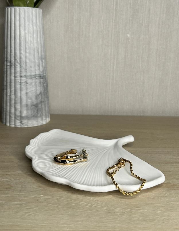 Handmade Home Accessories - An image of a white ginkgo leaf trinket tray, flat on a shelf to show the view from head on when it's placed on a surface.