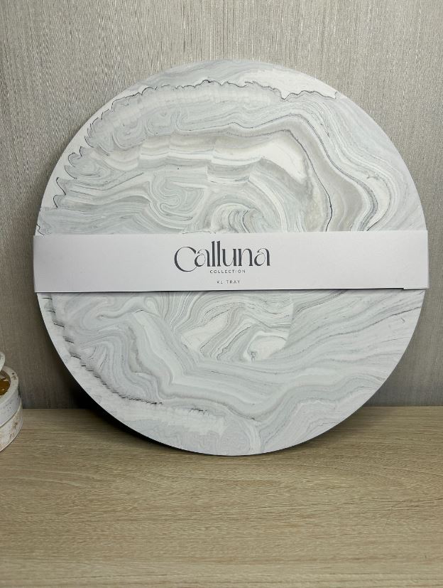 Handmade Home Accessories - a shot of a grey marble display plate with a belly band around the centre that says calluna collection.