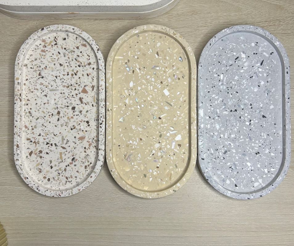 Handmade Home Accessories - Three terrazzo design trinket trays lined up that are off white, brown then grey themed.