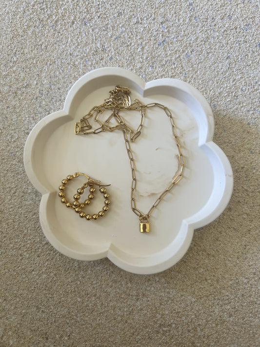 Handmade Home Accessories - a brown marble flower shaped trinket tray with a gold lock necklace and bubble gold hoops on