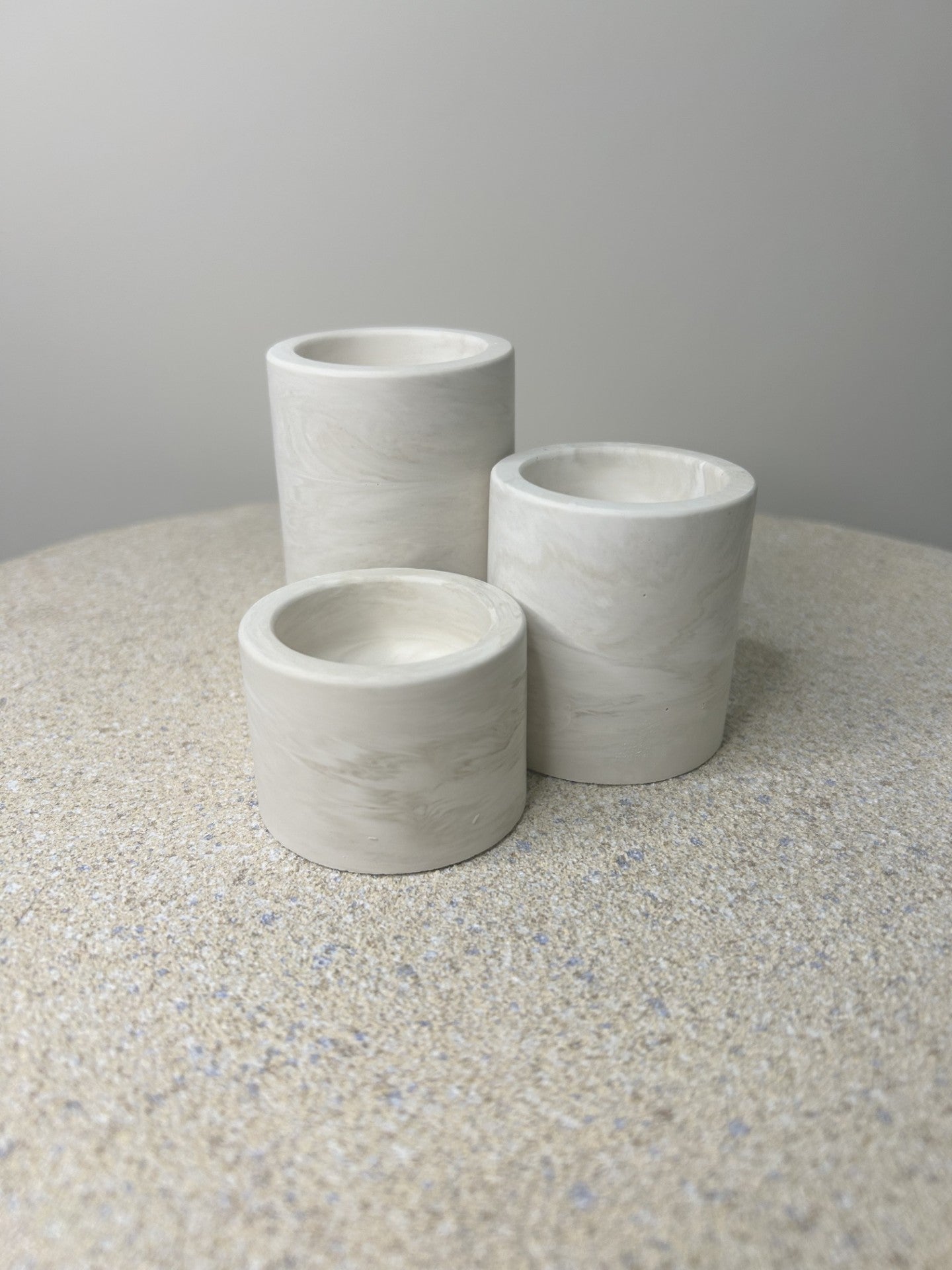 Handmade Home Accessories - A trio of candle holders with no tealights in, in a greige marble pattern.