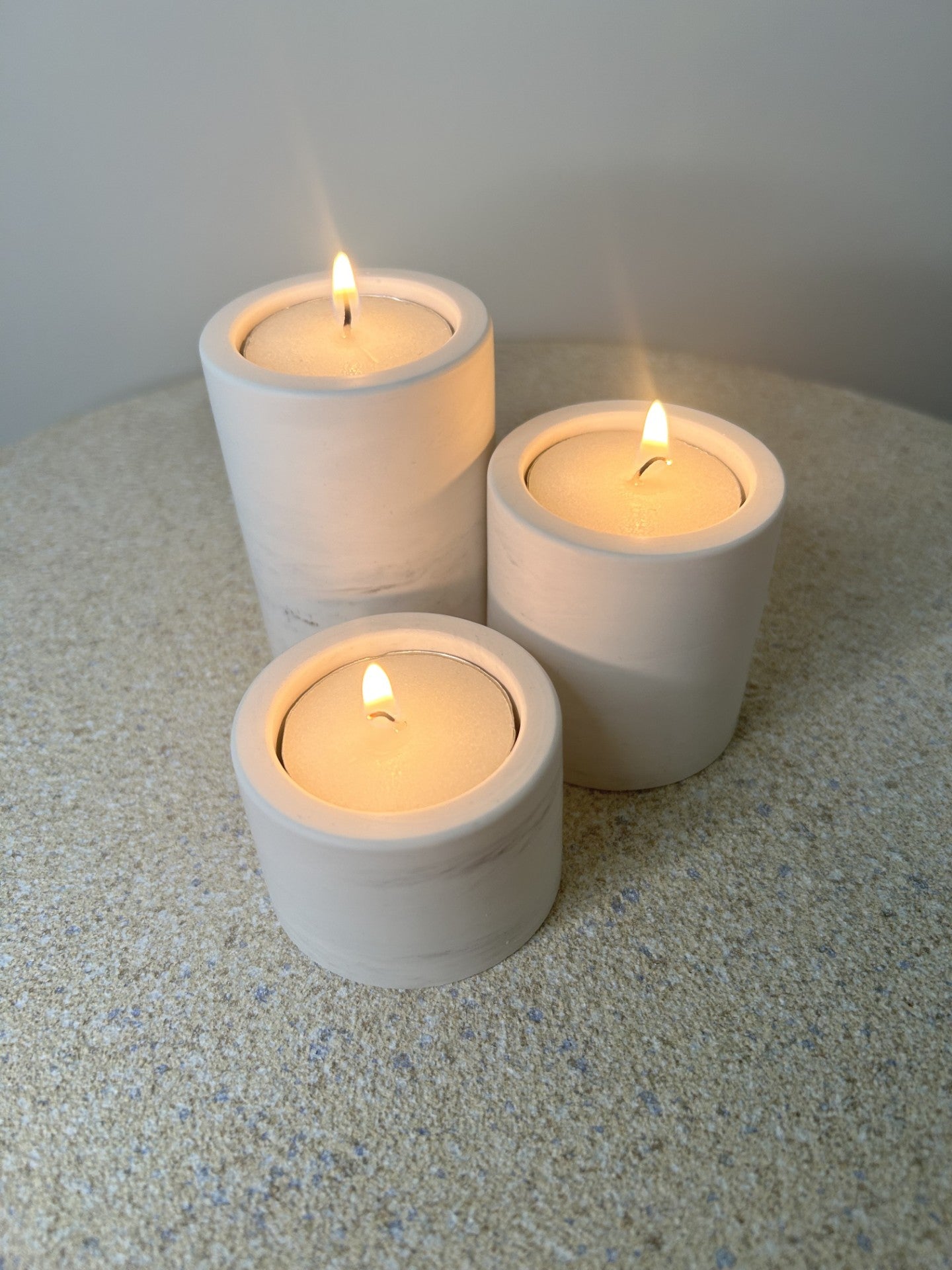 Handmade Home Accessories - three candle holders from a birds eye view showing lit tealights