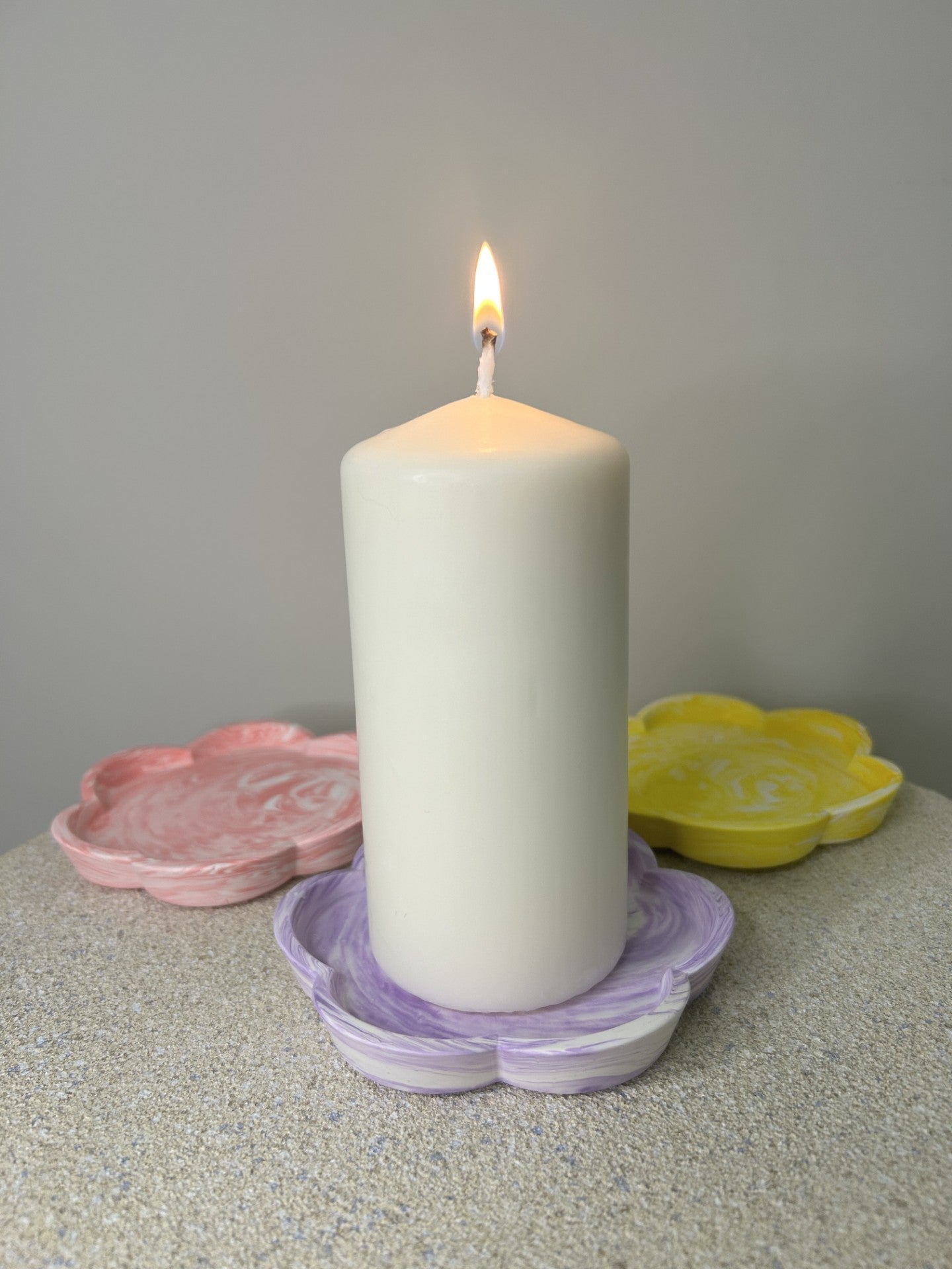 Handmade Home Accessories - A picture of a candle on the purple marble flower candle dish