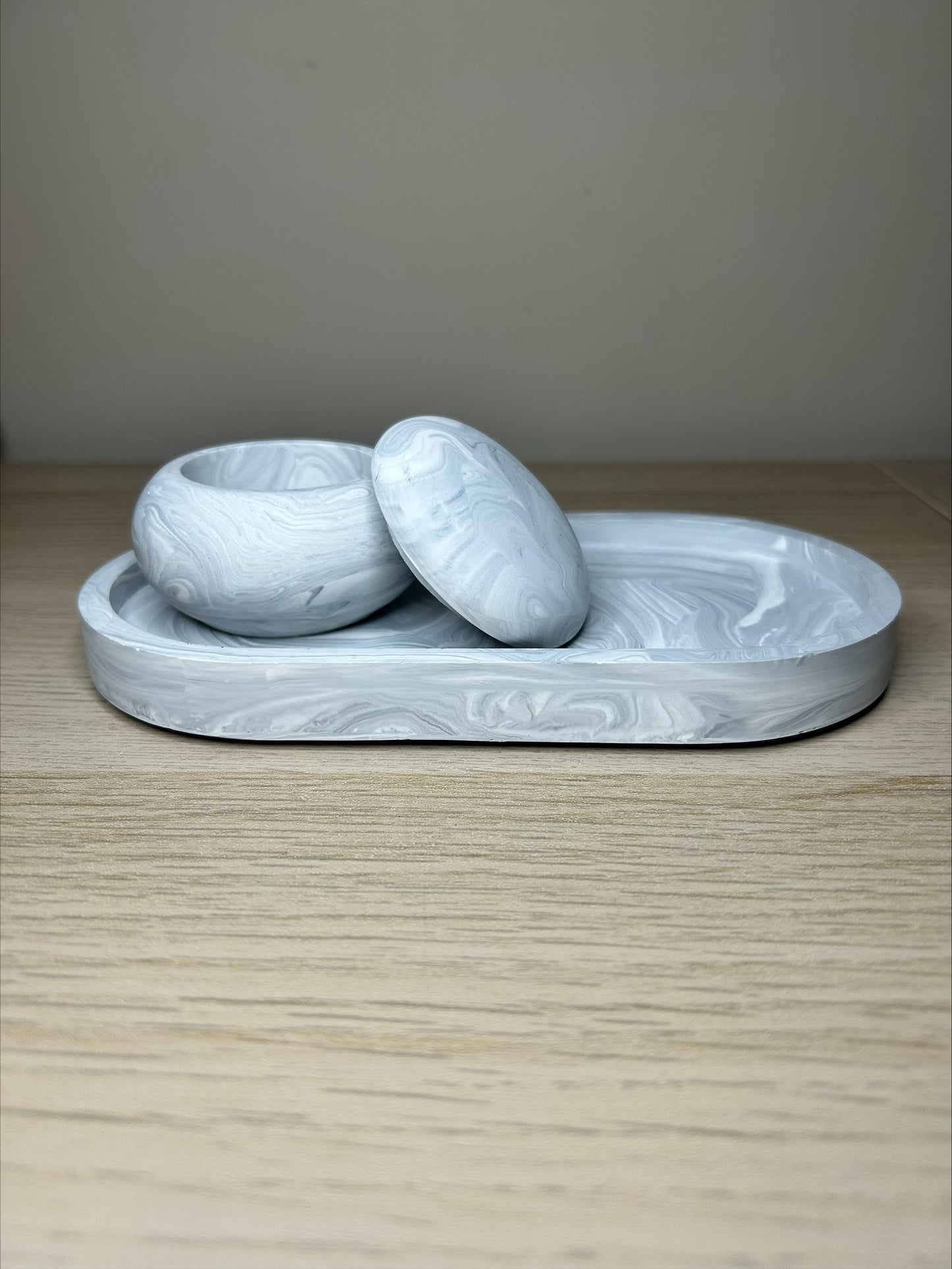 Handmade Home Accessories - a grey marble mushroom pot, open on a grey marble trinket tray on a wooden surface