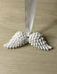 Handmade Home Accessories - a pair of white angel wings on a white ribbon on a wooden surface