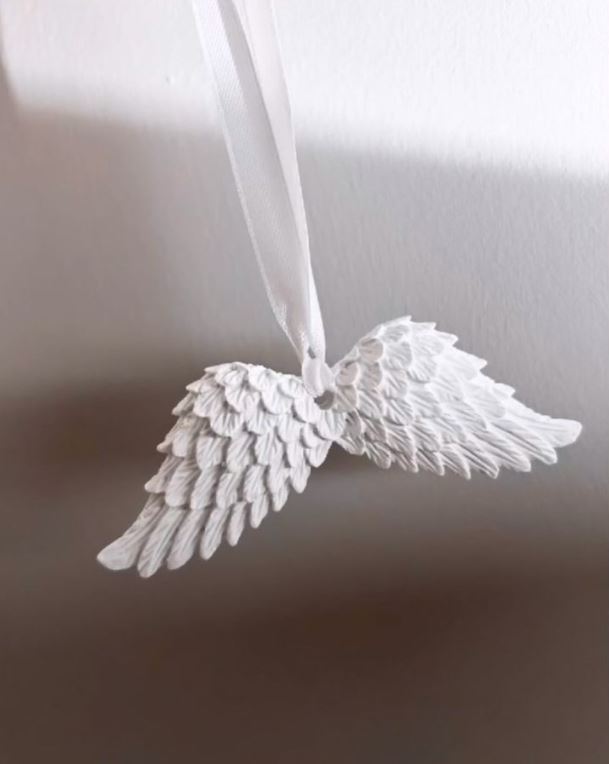 Handmade Home Accessories - a white pair of angel wings on a white background with shadows.